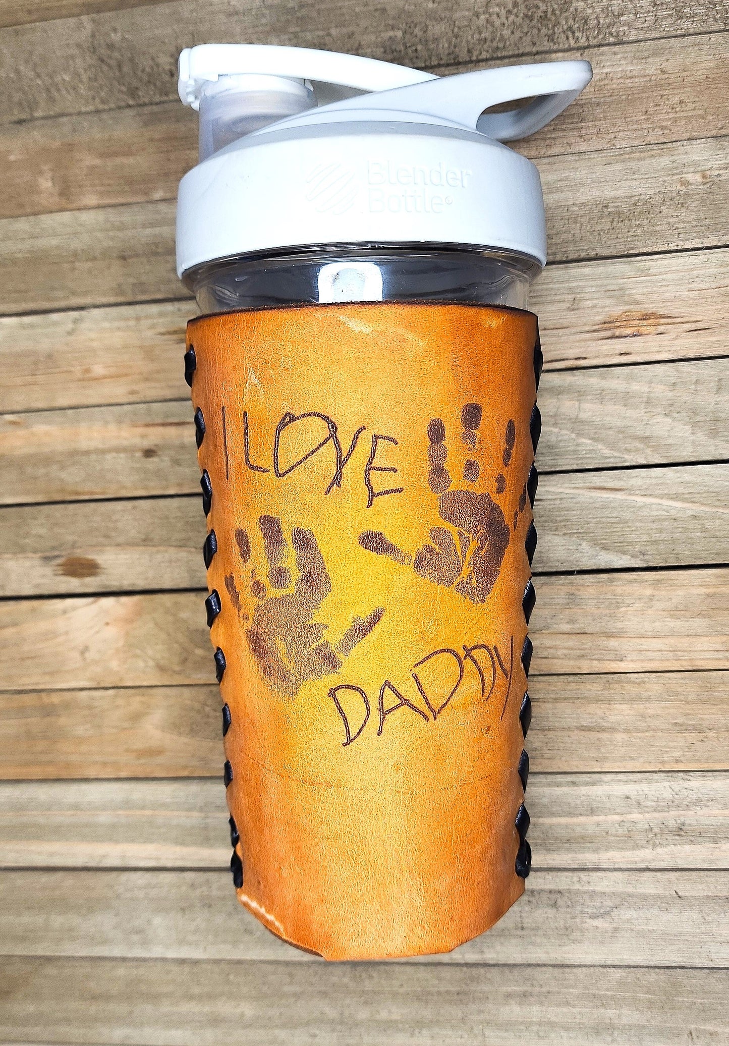 Perfect gifts for dads on Father's Day leather wrapped water bottle with kids handprints and handwritten message